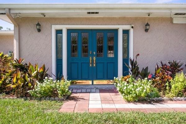 doorway to property with stucco siding