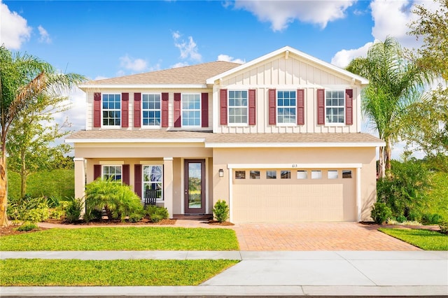 view of front of home featuring a front yard and a garage