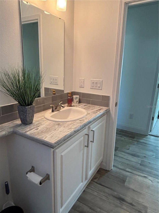 bathroom featuring hardwood / wood-style flooring and vanity