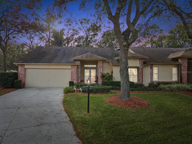 view of front of home featuring a garage and a lawn