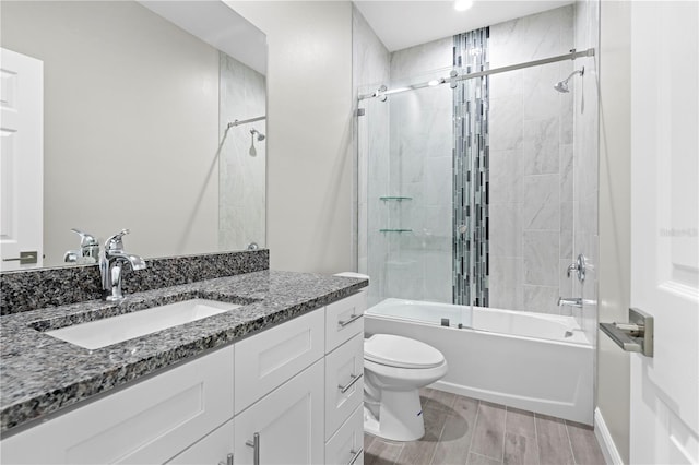 11345 Thrasher Ave, Weeki Wachee, FL 34614 - bathroom with toilet, shower / bath combination, vanity, wood finished floors, and baseboards