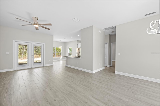 11345 Thrasher Ave, Weeki Wachee, FL 34614 - unfurnished living room featuring ceiling fan, light wood-style floors, baseboards, and recessed lighting