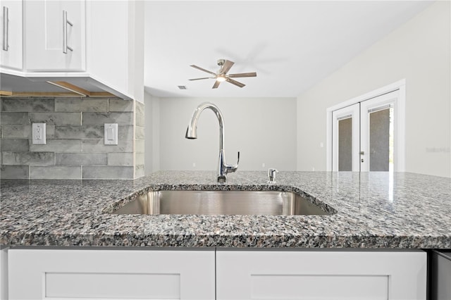 11345 Thrasher Ave, Weeki Wachee, FL 34614 - kitchen featuring a sink, dark stone countertops, tasteful backsplash, french doors, and white cabinets