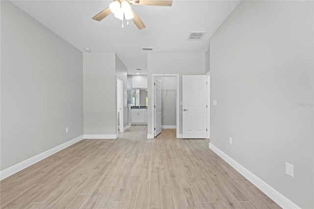 11345 Thrasher Ave, Weeki Wachee, FL 34614 - spare room with a ceiling fan, light wood-style flooring, and baseboards