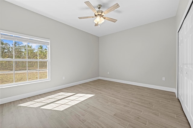 11345 Thrasher Ave, Weeki Wachee, FL 34614 - spare room featuring baseboards and light wood-style flooring