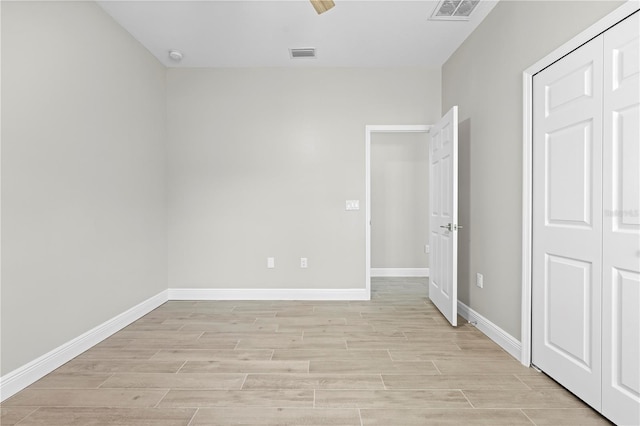 11345 Thrasher Ave, Weeki Wachee, FL 34614 - unfurnished bedroom with light wood finished floors, baseboards, a closet, and ceiling fan