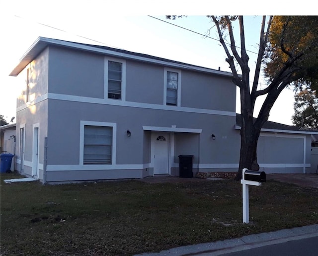 view of front of house featuring a garage and a front yard