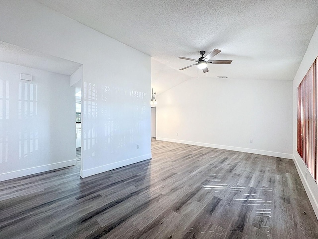 unfurnished room featuring a textured ceiling, lofted ceiling, dark hardwood / wood-style floors, and ceiling fan