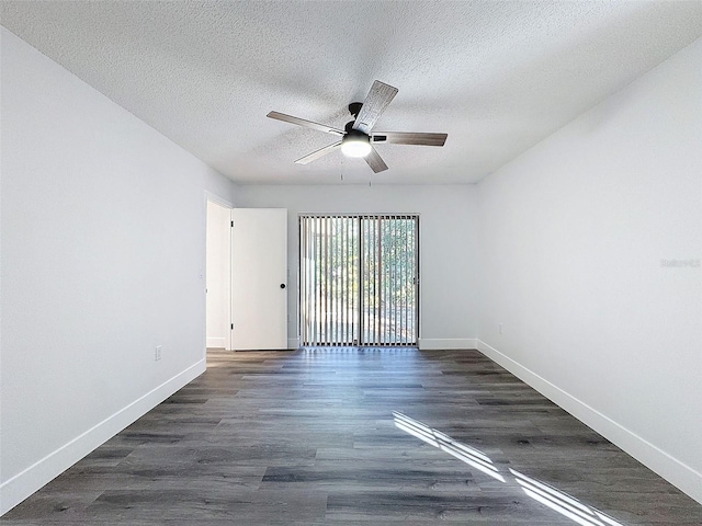 empty room featuring ceiling fan, dark wood-type flooring, and a textured ceiling