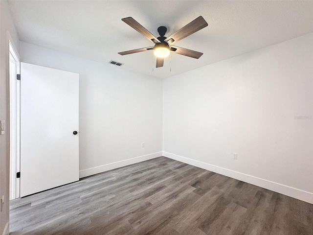 empty room with ceiling fan and wood-type flooring