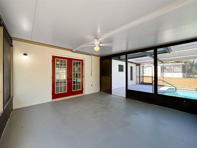 unfurnished sunroom featuring french doors and ceiling fan