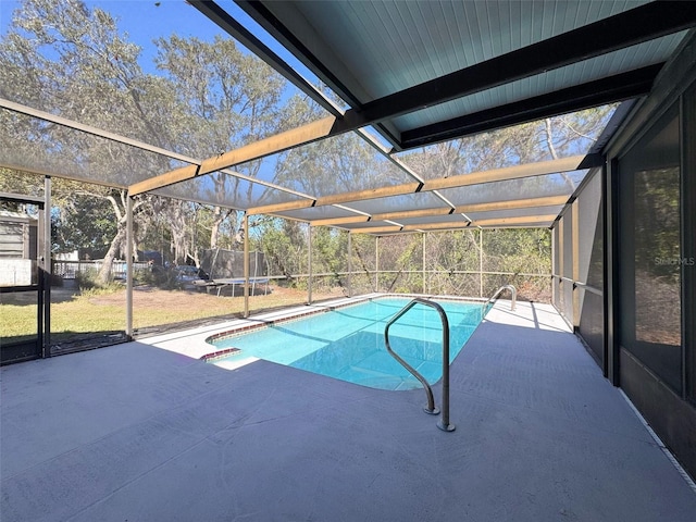 view of pool featuring glass enclosure and a patio