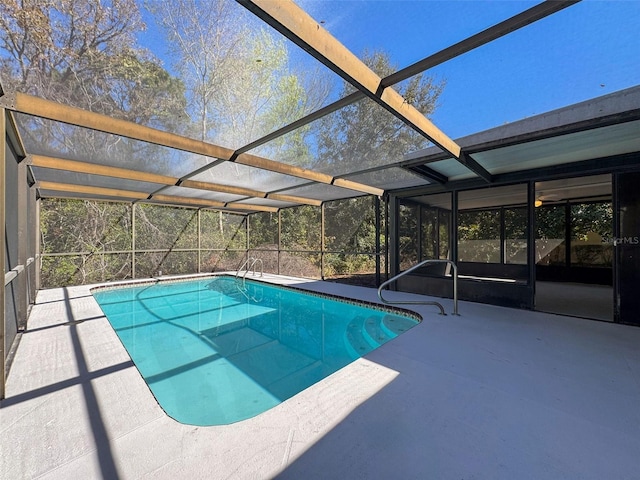 view of pool featuring a patio and glass enclosure