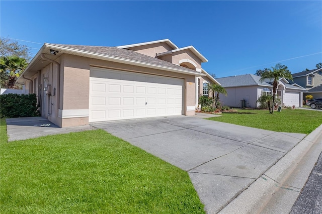 view of front facade with an attached garage, a shingled roof, driveway, stucco siding, and a front lawn