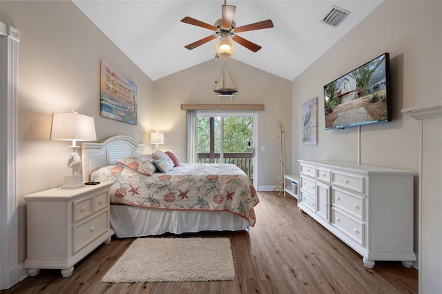 bedroom featuring dark wood-style floors, access to outside, visible vents, and vaulted ceiling