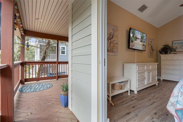 wooden deck featuring visible vents