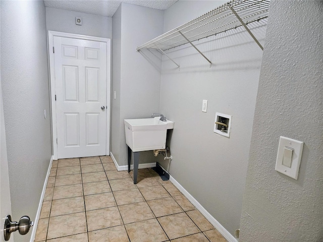 laundry room with washer hookup, laundry area, light tile patterned flooring, and baseboards