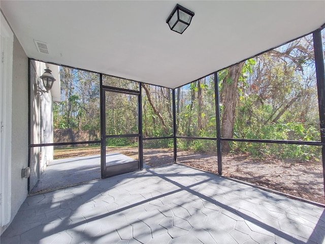 unfurnished sunroom with visible vents