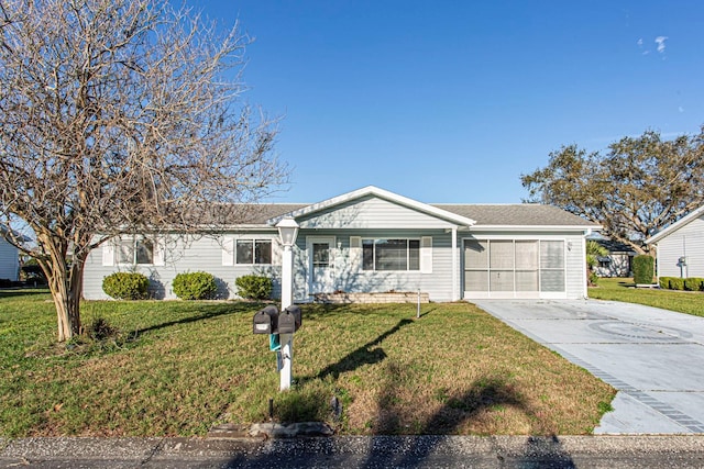 ranch-style home featuring a garage, driveway, and a front lawn