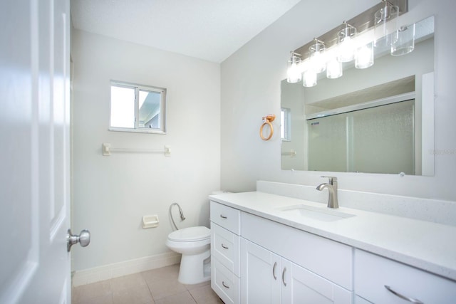 bathroom with toilet, a stall shower, vanity, baseboards, and tile patterned floors