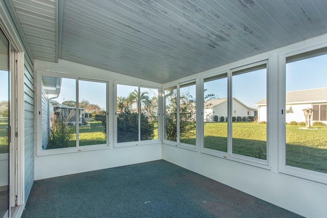 unfurnished sunroom featuring wooden ceiling and vaulted ceiling