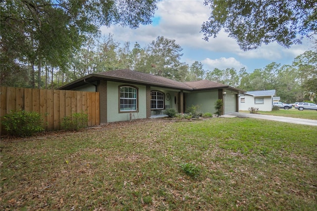 single story home with a front yard and a garage