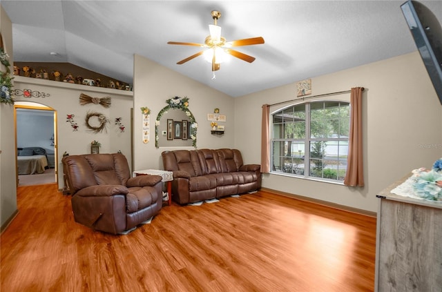 living room featuring lofted ceiling, ceiling fan, and light hardwood / wood-style flooring