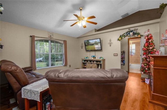 living room featuring ceiling fan, wood-type flooring, and lofted ceiling