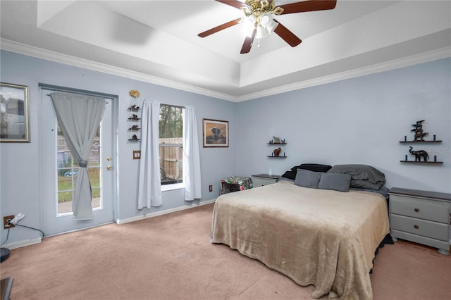 carpeted bedroom with a tray ceiling, crown molding, access to outside, and ceiling fan