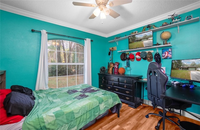 bedroom with hardwood / wood-style floors, ceiling fan, crown molding, and a textured ceiling