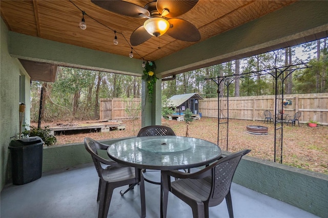 sunroom / solarium with ceiling fan and wood ceiling