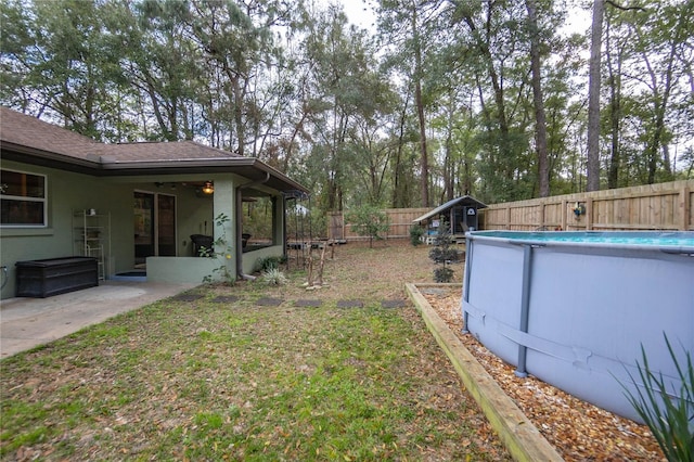 view of yard with a sunroom, a fenced in pool, and a patio area