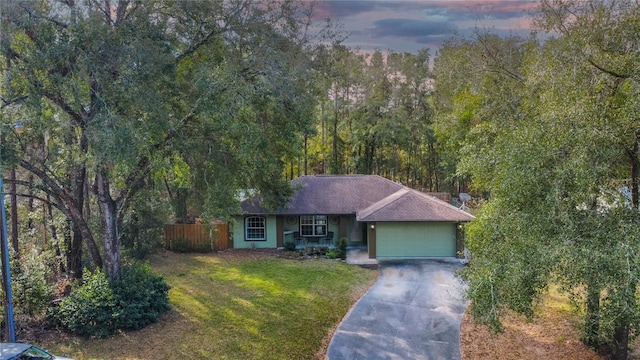 view of front of house featuring a garage and a lawn