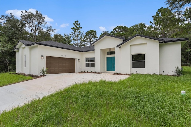 view of front of home with a garage and a front yard