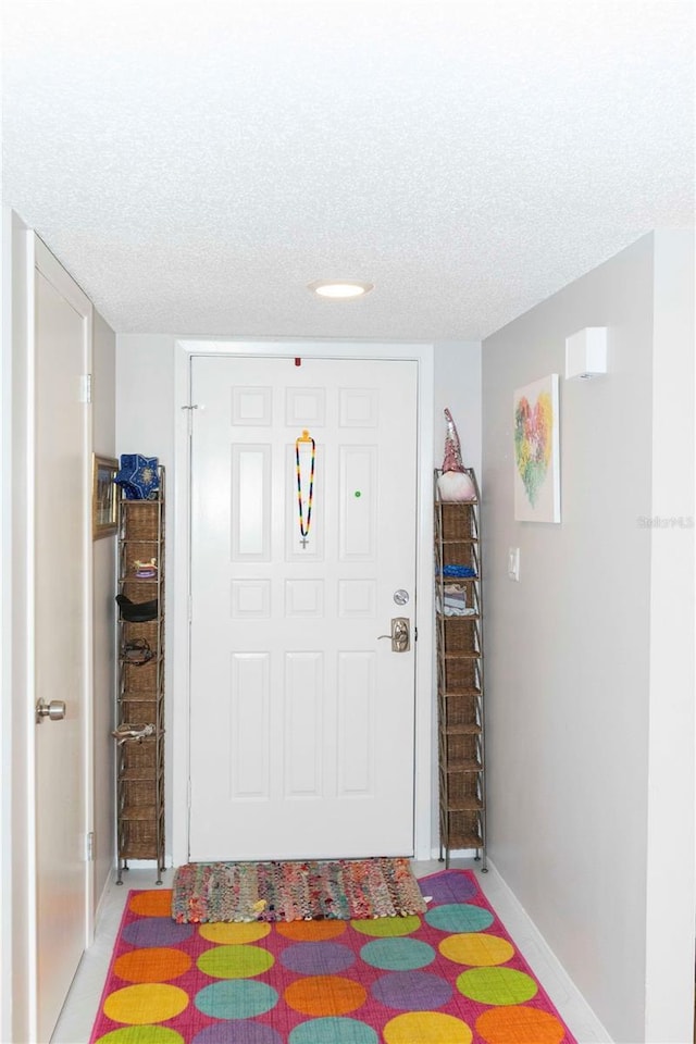 foyer entrance with a textured ceiling