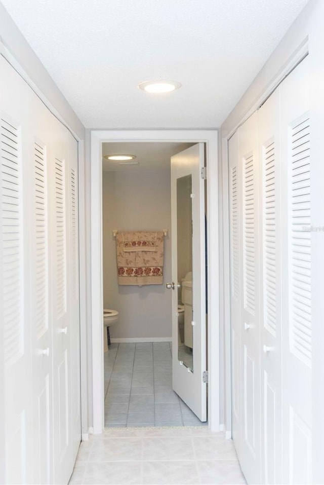 corridor with light tile patterned floors