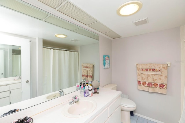 bathroom featuring vanity, toilet, and tile patterned floors