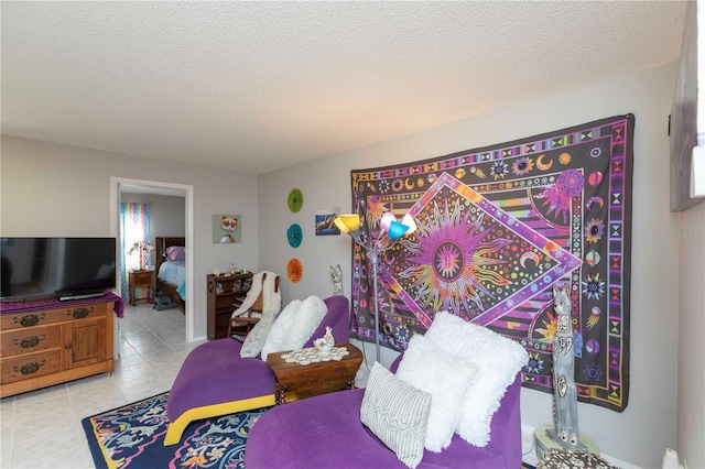 bedroom with light tile patterned flooring and a textured ceiling