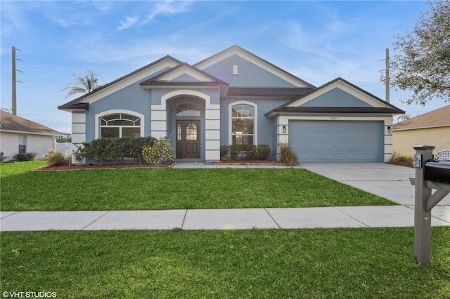 single story home featuring a garage and a front lawn