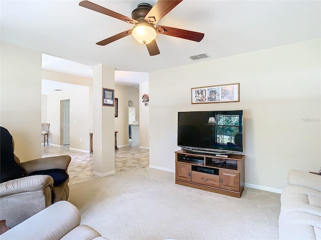 living room with ceiling fan and light colored carpet