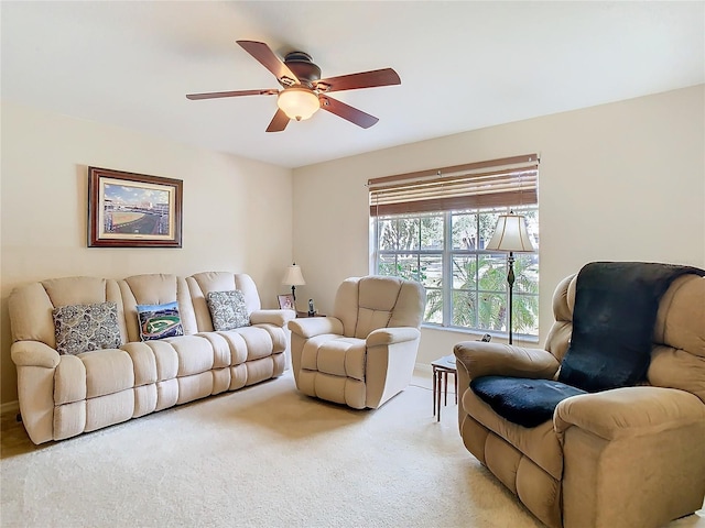 carpeted living room featuring ceiling fan