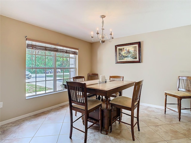 dining area with a notable chandelier, a wealth of natural light, and light tile patterned floors