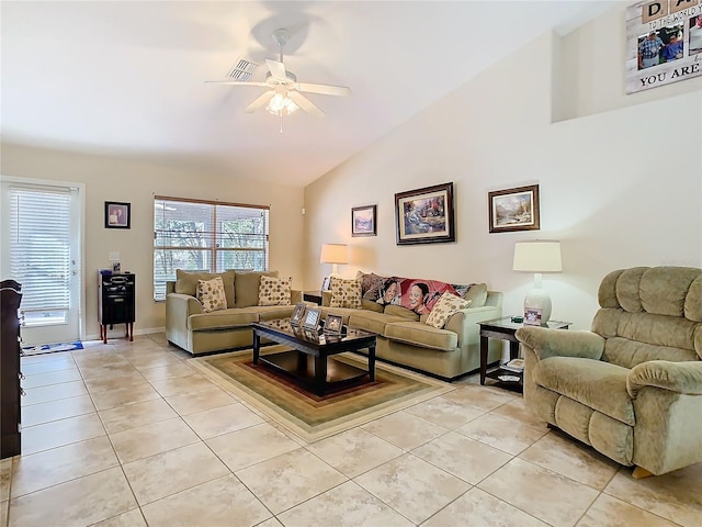 living room featuring vaulted ceiling, light tile patterned flooring, and ceiling fan