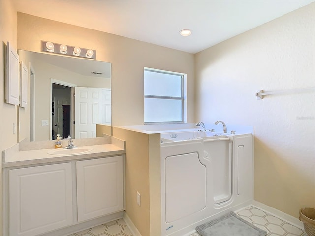 bathroom with vanity and a bath