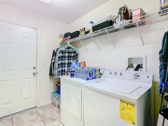 laundry area featuring independent washer and dryer and light tile patterned floors