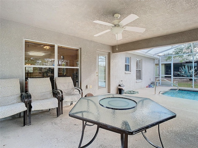 sunroom with a wealth of natural light and ceiling fan