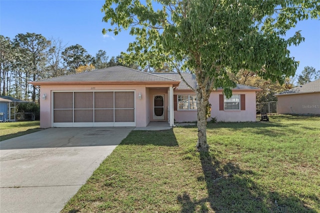 ranch-style house with stucco siding, an attached garage, concrete driveway, and a front yard