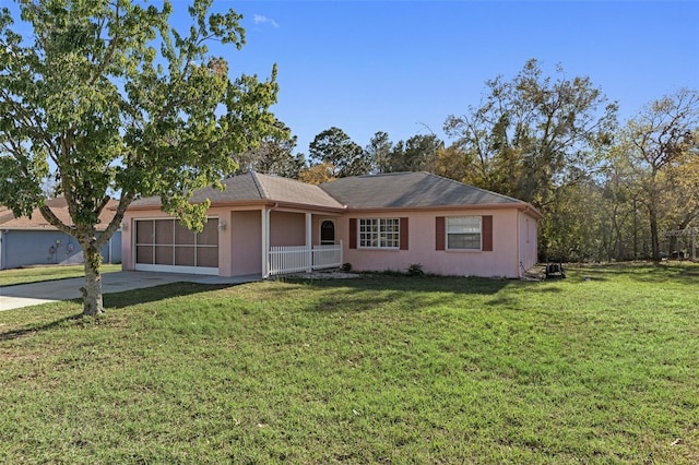 single story home with stucco siding, a front lawn, driveway, a sunroom, and a garage