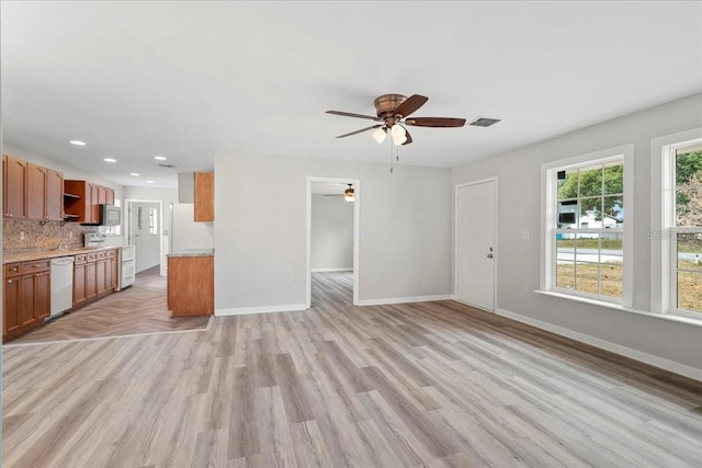 unfurnished living room with ceiling fan and light hardwood / wood-style floors