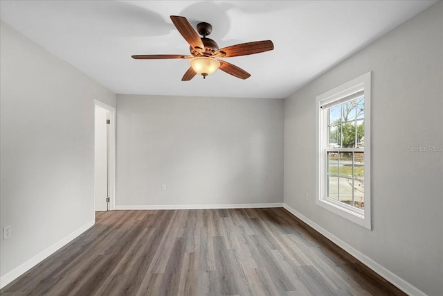 spare room with hardwood / wood-style floors and ceiling fan